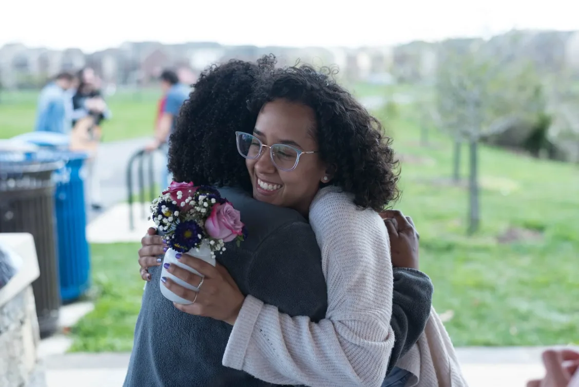 Two people embracing outdoors